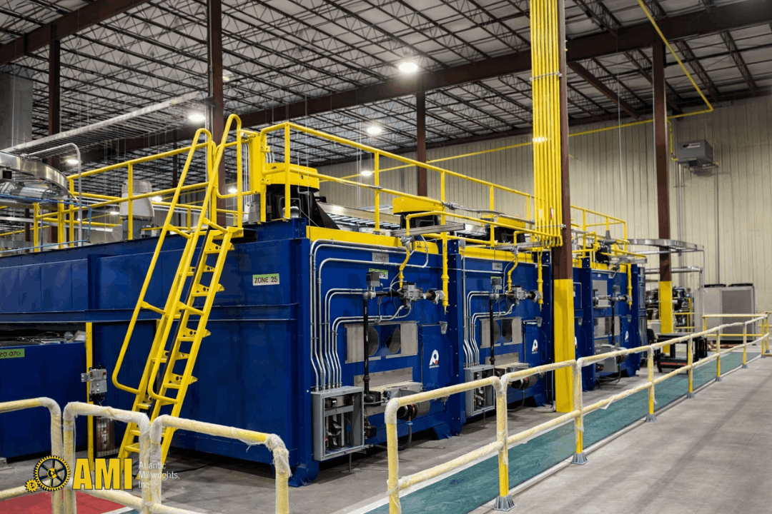 manufacturing equipment setup inside warehouse with conveyor system and safety barriers